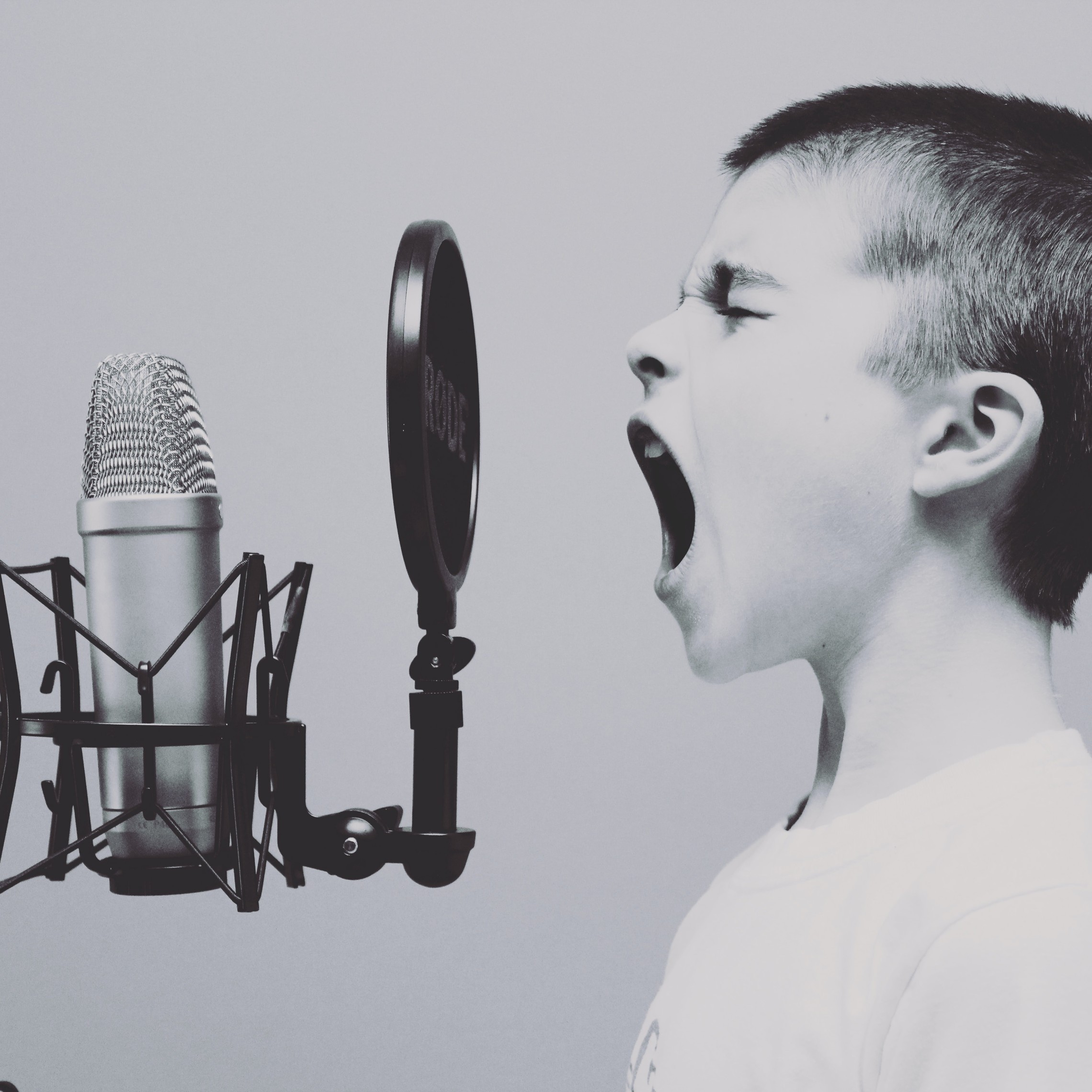 Boy screaming into microphone