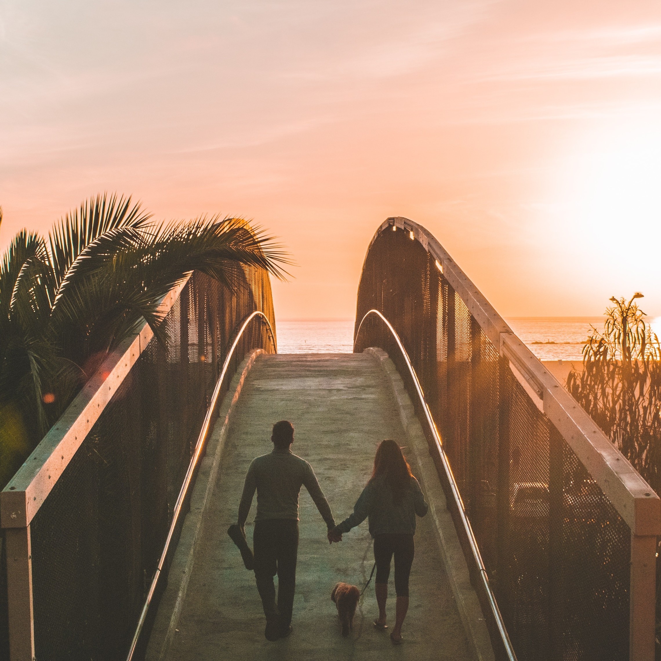 Couple walks across bridge